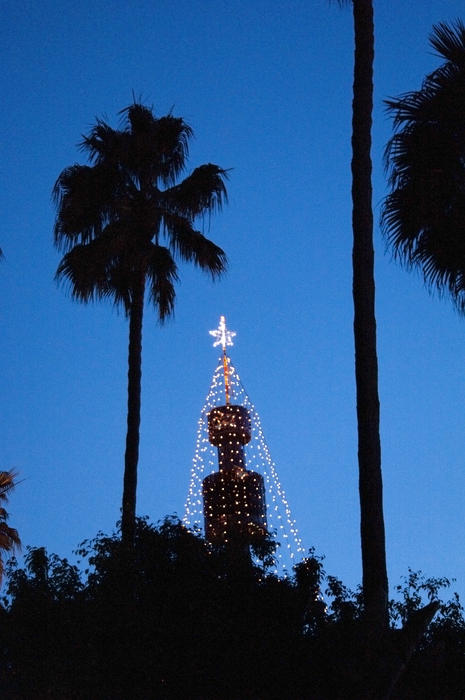 a tower decorated with streams of holiday lights