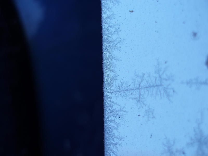frost growing in a fractal pattern on a chomed metal strip