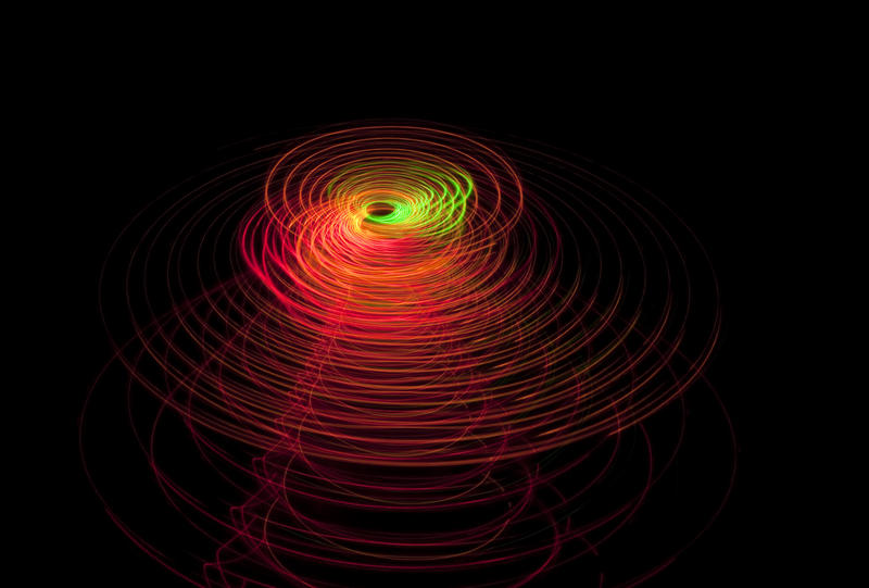 red coloured rings of light centered around a bright orange and green centre