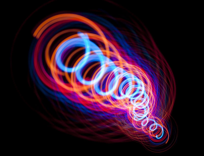 a brightly coloured image featuring a coiled 'tube' of red, orange and cyan light