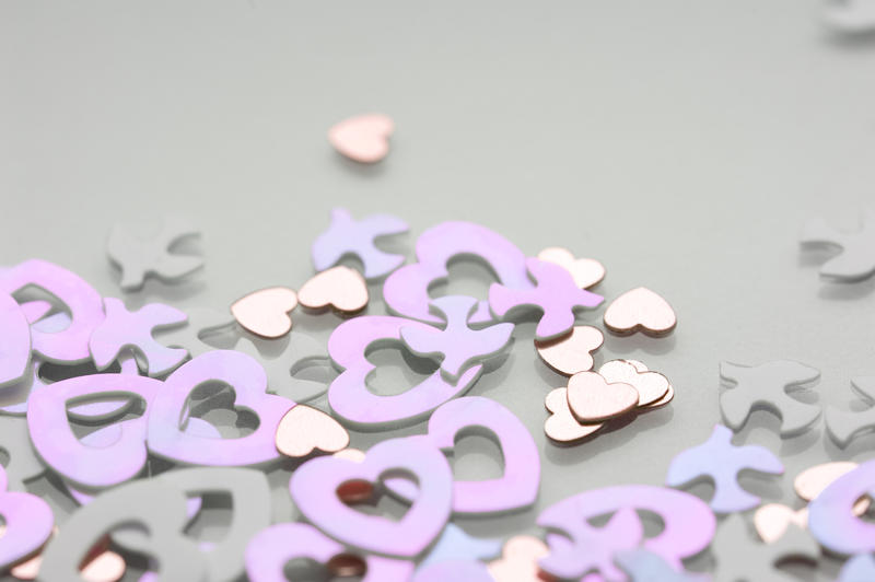 close up on pink heart shaped valentine decorative confetti with space for text