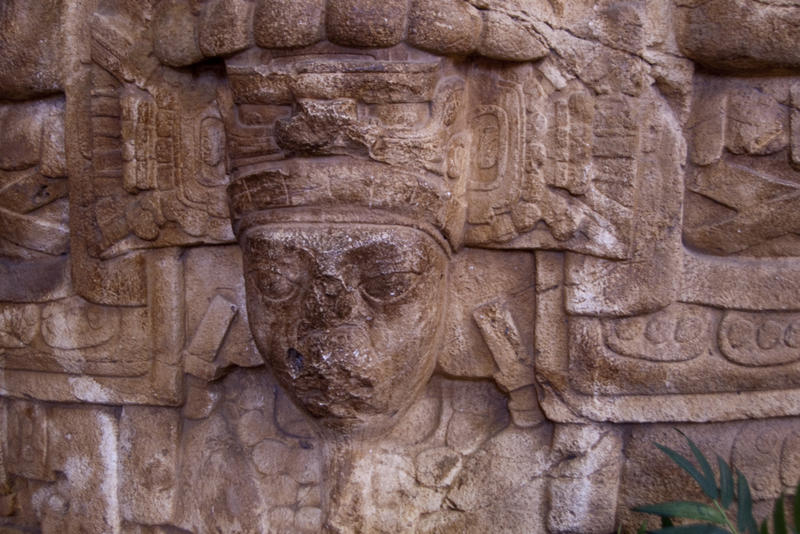 mask of a face carved into stone