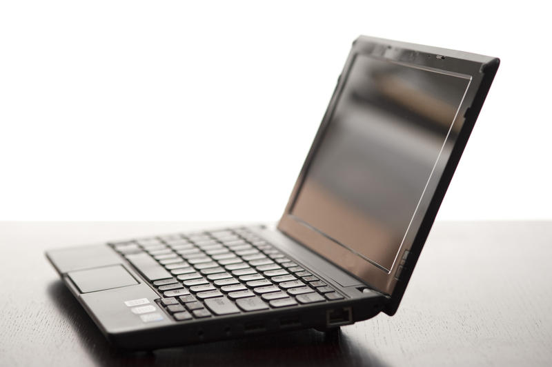 a netbook computer pictured at an angle with the lid open with a narrow depth of field