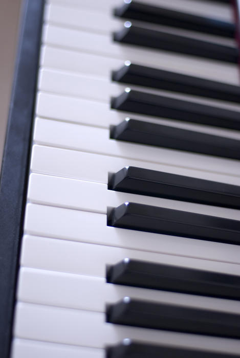closeup on the keys on a piano keyboard