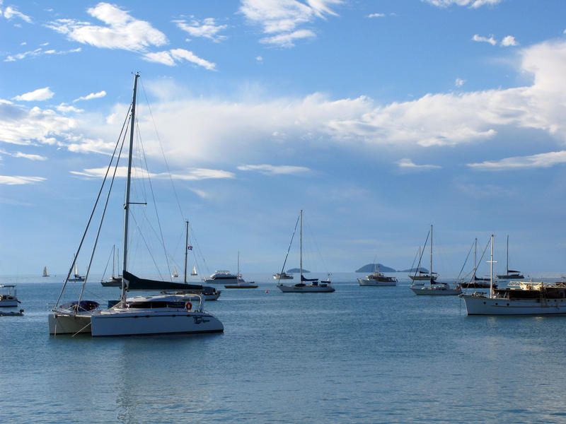 sailing yachts and catamarans moored in pioneer bay off the shores of airlie beach