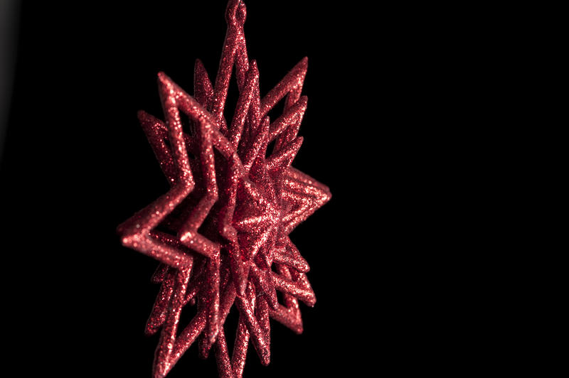 a red sparkly christmas star shaped tree ornament