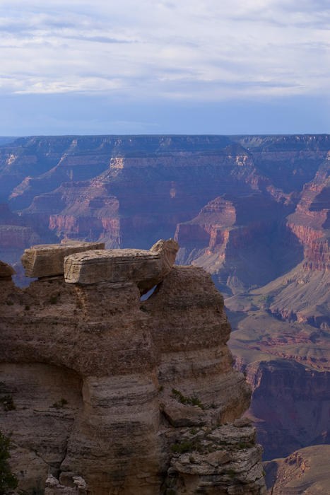 interesting rock formation framed by a background of the grand canyon