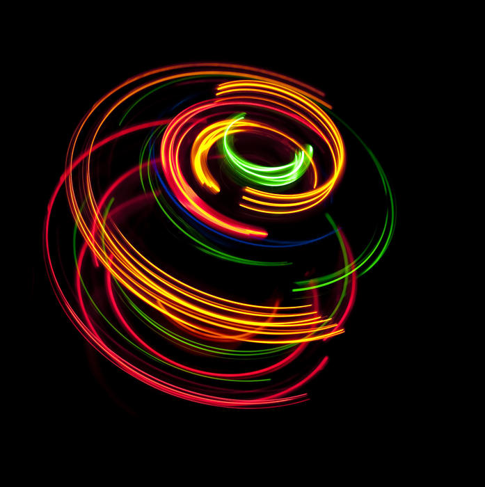 colorful glowing arcs of light tracing a 3D circular pattern