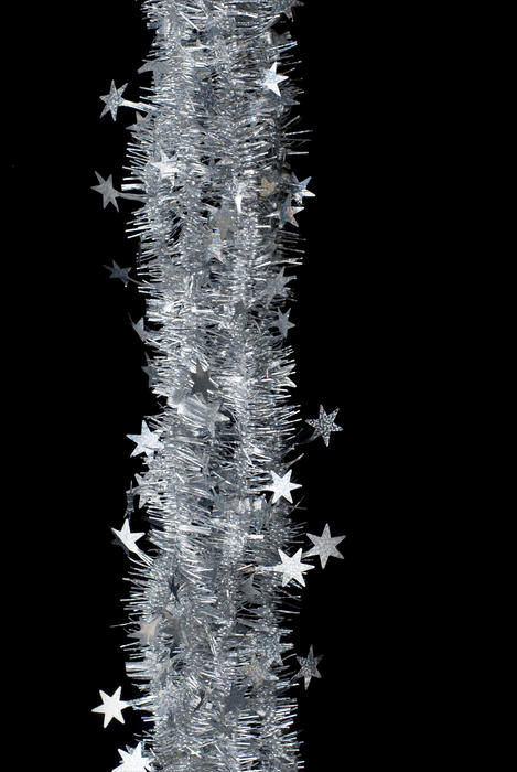 a string of silver tinsel on a black background