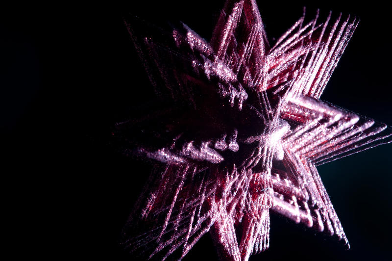 a multiple exposure motion effect christmas star on a dark backdrop