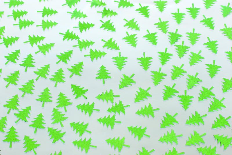 a festive background of green pine tree shapes on white