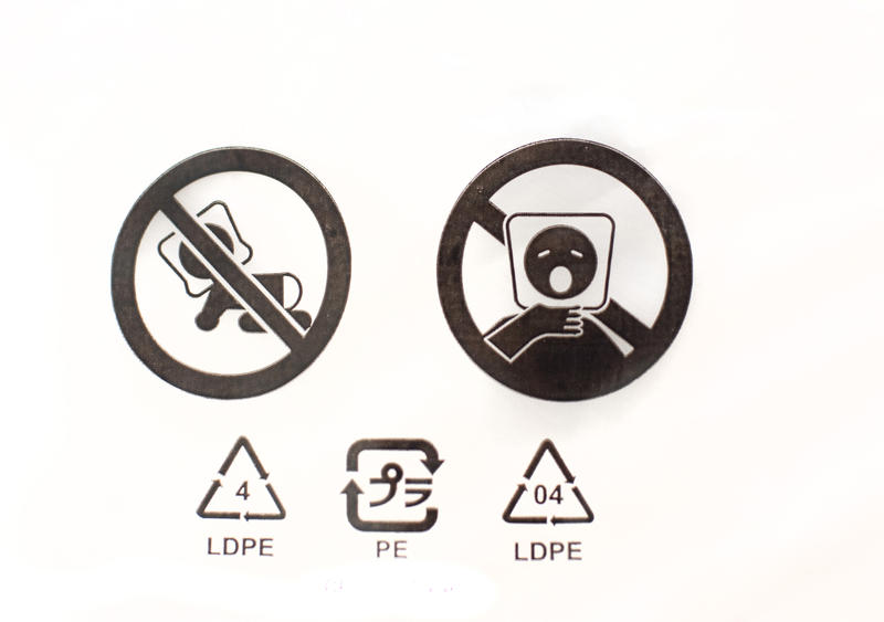 symbols on a plastic wrapper warning of suffocation