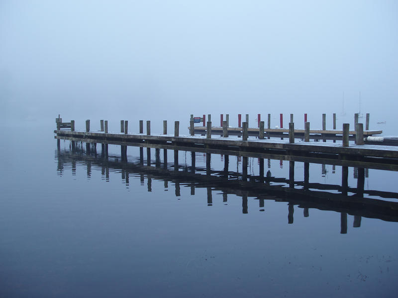a jetty at fell foot on lake windermere on a misty day