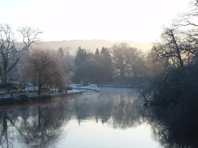 a cold winter morning looking out onto the end of lake windermere at newby bridge