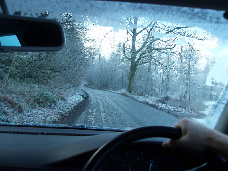 driving on icy roads with frost on the windscreen