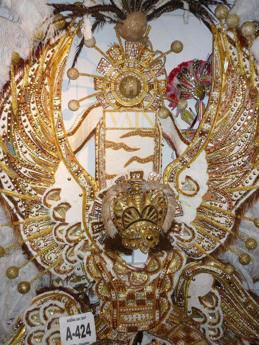 a flamboyant festival costume with pearls and gold beads