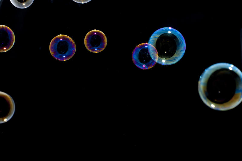 close up on some floating soap bubbles showing patterns in the bubbles soap film