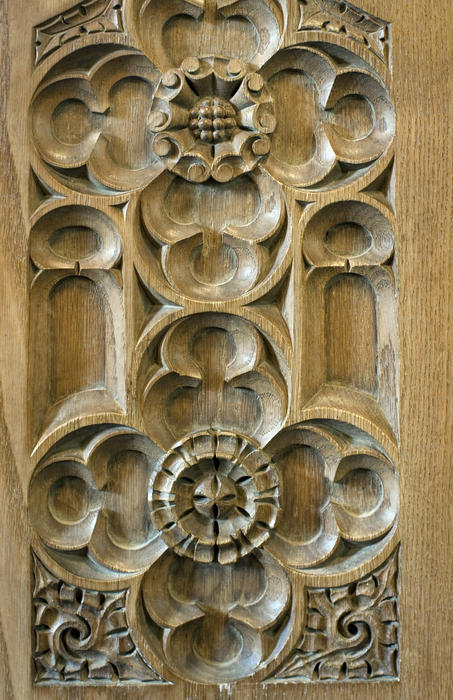 a carved wooden panel with a floral design