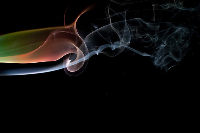 colorful abstract smoke patterns against a black background