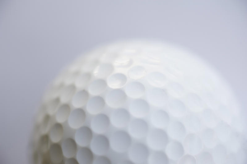 a close up image of a golf ball on a white background