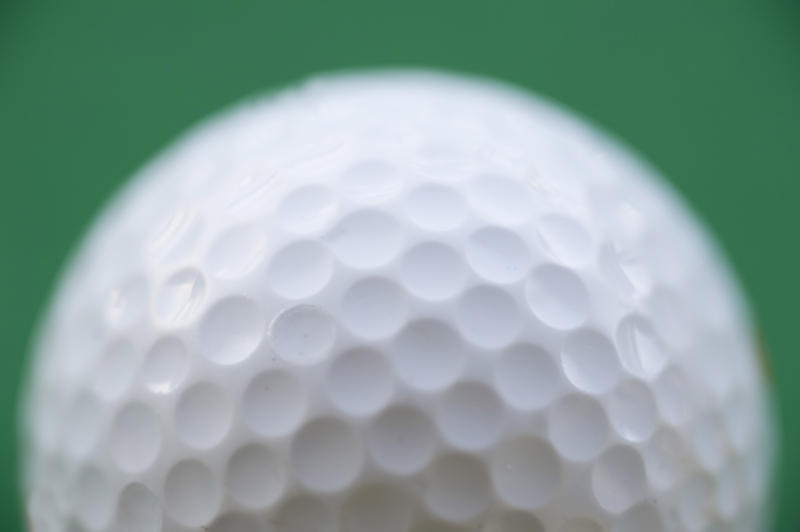 a golf ball on a green background