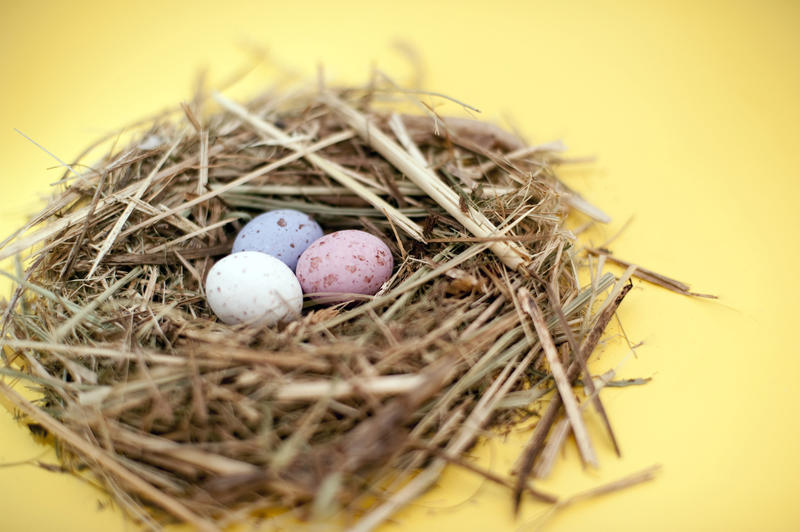 Small straw nest filled with three mini Easter Eggs of speckled sugar candy