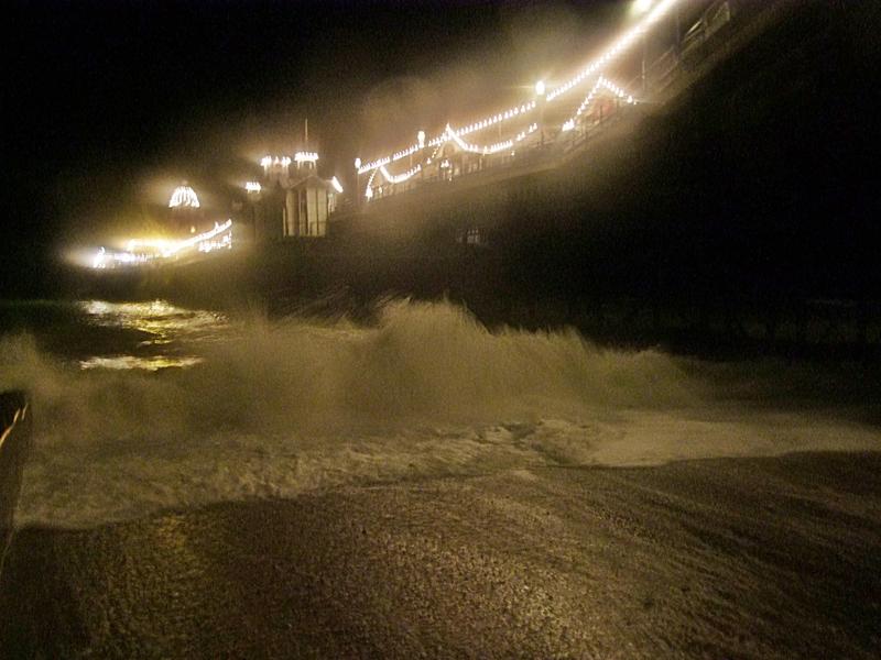 <p>atmospheric image of a storm battering a coast line - grainy/blurry</p>
