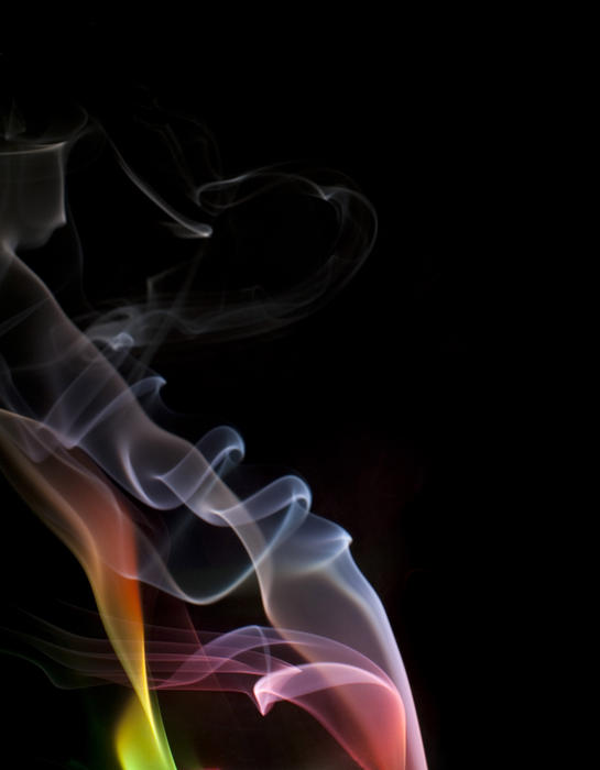 colorful illuminated particles of smoke vapor