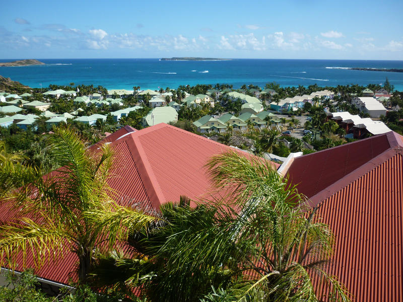 a view out to sea over rooftops on the island of st maarten