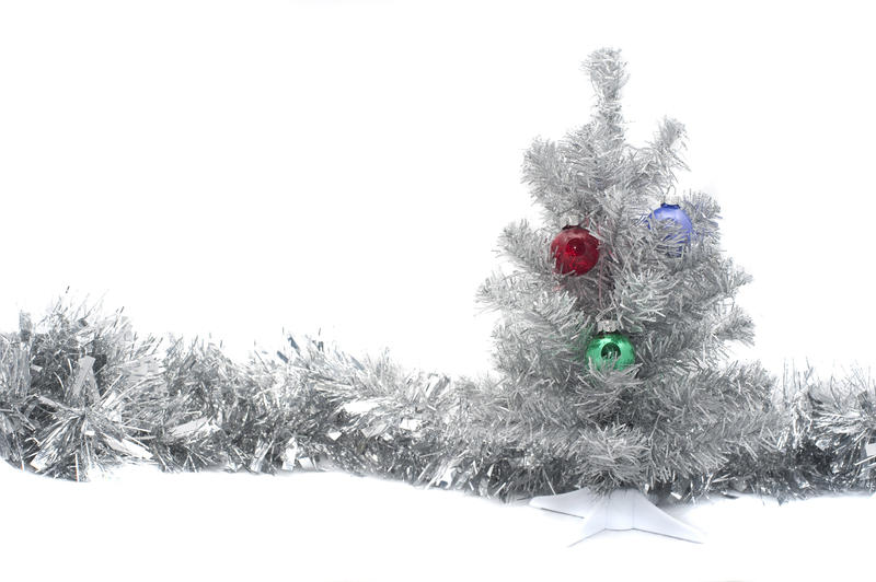 a silver colored artifical chritmas tree and a line of silver tinsel
