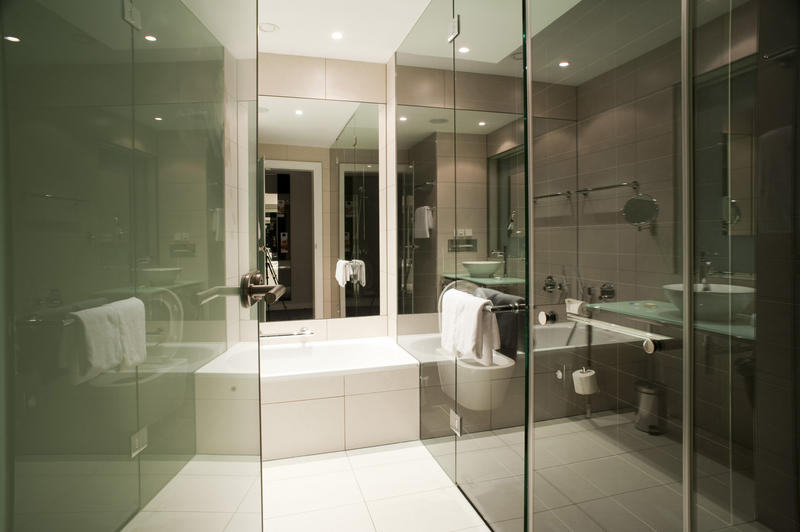 Modern bathroom with lots of glass and white tiles