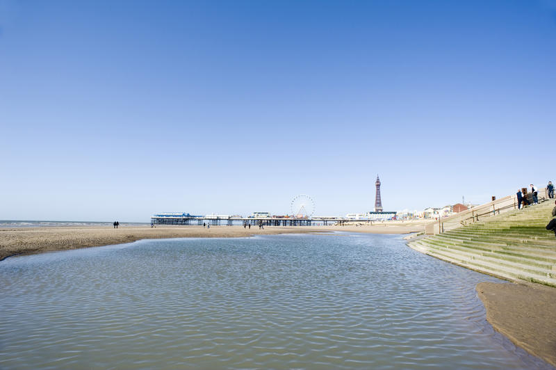low tide leaves a pool of water on the sandy foreshore at blackpool, lancashire, england