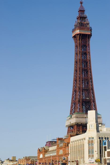 Closeup view of the Blackpool Tower from the promenade on a sunny summer day against clear blue sky showing the lattice structure