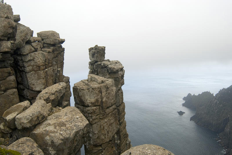 precarious rock formations perched high on the cliffs of cape pillar