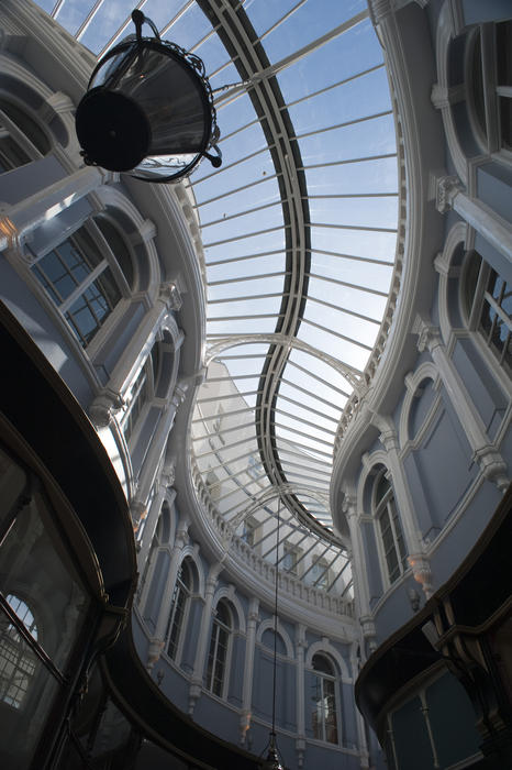 View inside the Morgan Arcade, a shopping arcade in Cardiff of the Venetian windows, some of which are still original, and the stylish curving glass roof which were both restored recently