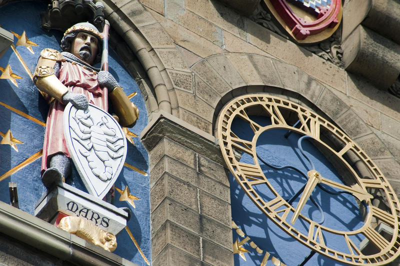Cardiff Castle Clock Tower detail with the gilded clock flanked by the figure of Mars with his shield representing the planet Mars