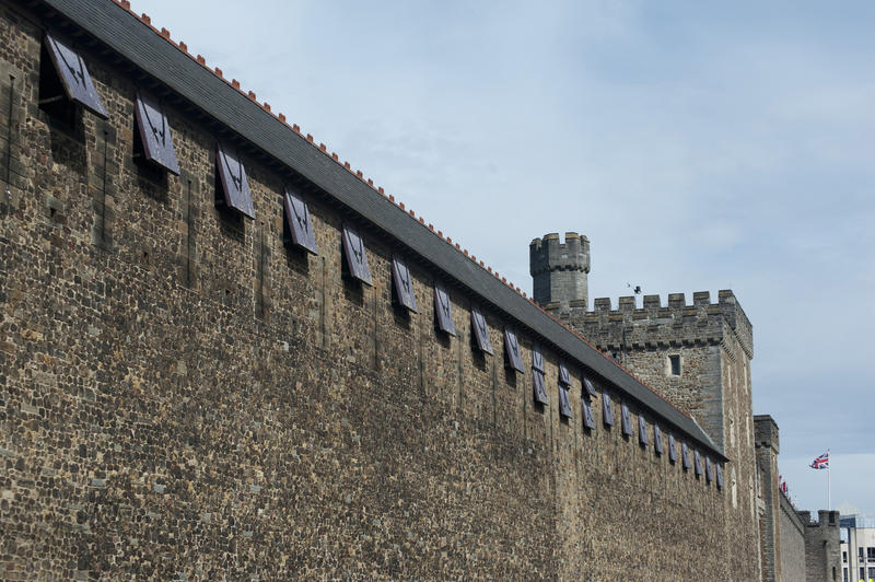 Exterior view of the stonework and crenellated tower on the walls at Cardiff Castle in Wales