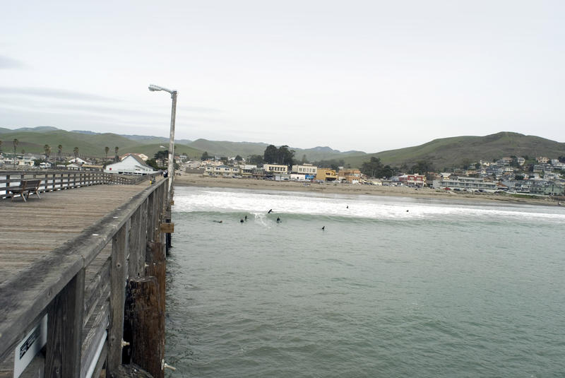 View from a wooden pier towards the town of Cayucos, California