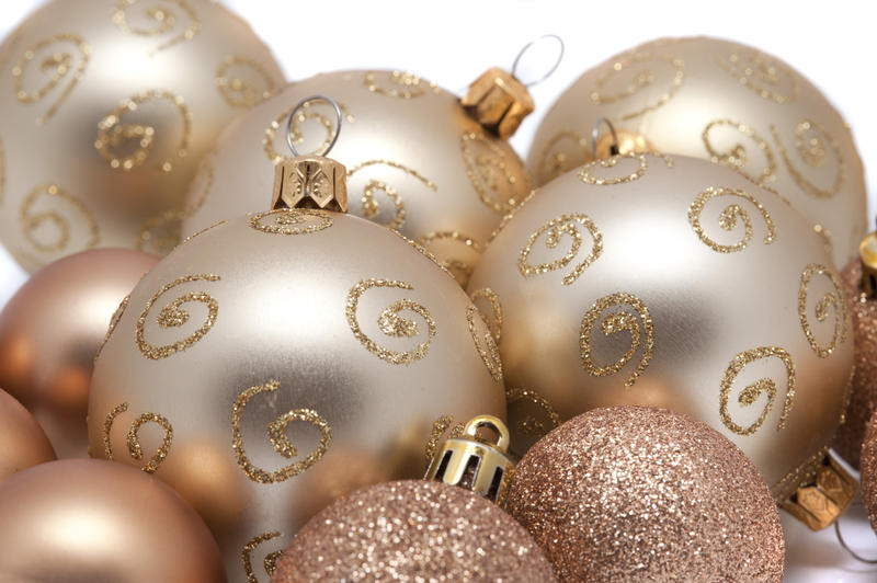 Collection of gold Chritsmas baubles with textured glitter surfaces of curlicue glitter patterns