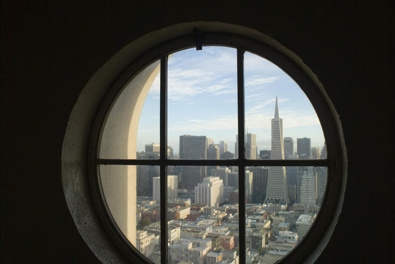 looking out of the coit tower towards downtown san francisco