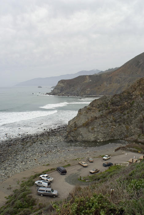 cars parked at a vista point on californias pacific coastline