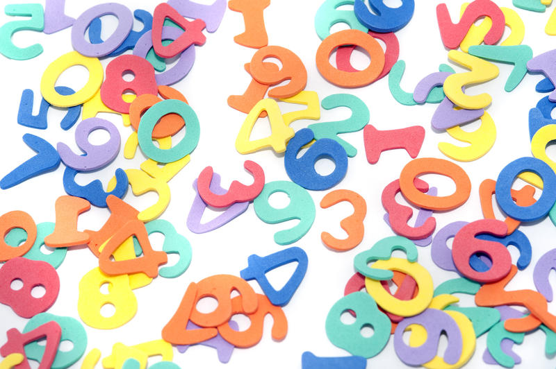 Colourful numbers scattered on white for teaching young preschool and kindergarten children basic sums and arithmetic