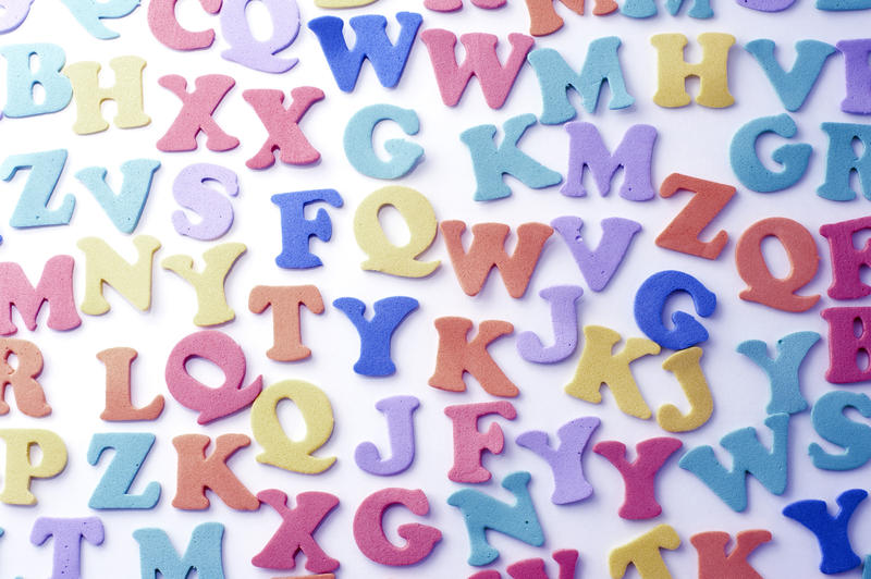 Spread out multicolored plastic letters of the alphabet