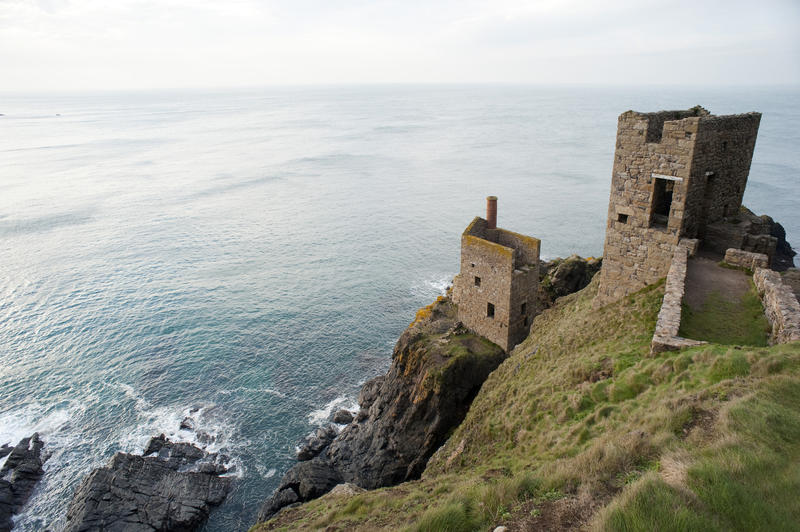 The two ruined engine houses of the Crown Mines, Botallack perched on cliffs overlooking the Atlantic Ocean and the undersea shafts, a part of the West Devon Mining Landscape World Heritage Site