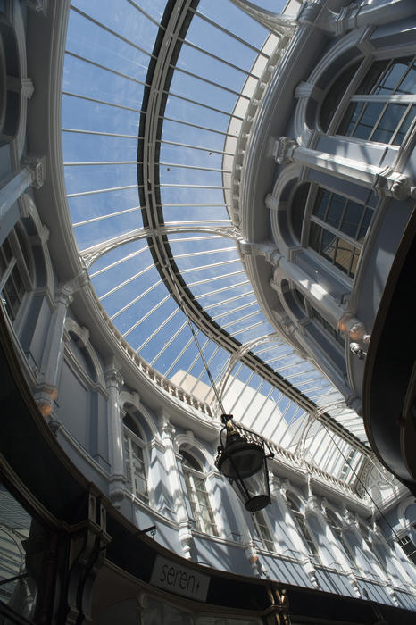 The curving glass roof and restored Venetian windows of the historical Victorian shopping arcade known as the Morgan Arcade, Cardiff, Wales