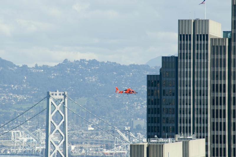 a helicopter flying through the san francisco city skyline
