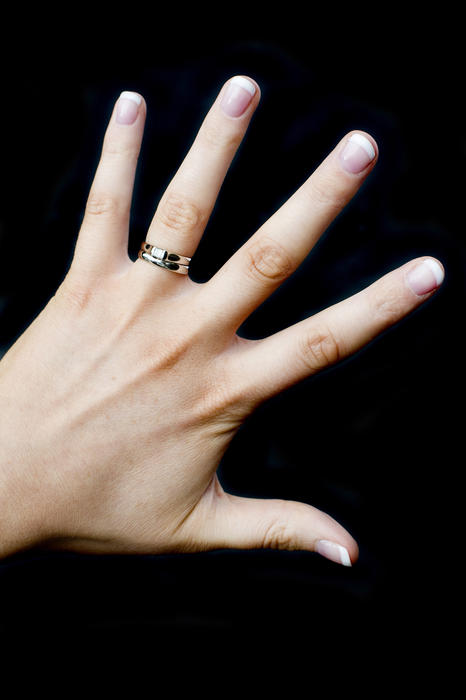 cut out on a black background, a young woman wearing wedding and engagement rings