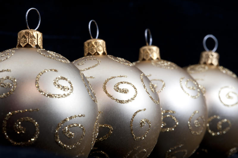 Glitter patterned silver Christmas balls arranged in an oblique row with diminishing perspective and shallow dof