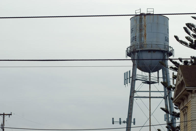 water tower stands over the town of guadalupe, california