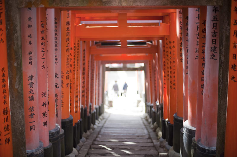 people walking through the tunnels of torii gates at the funari inari shrine, kyoto, japan